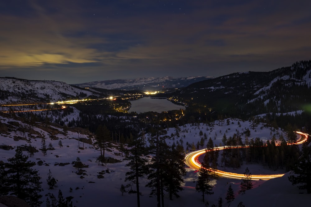 a night time view of a road in the mountains