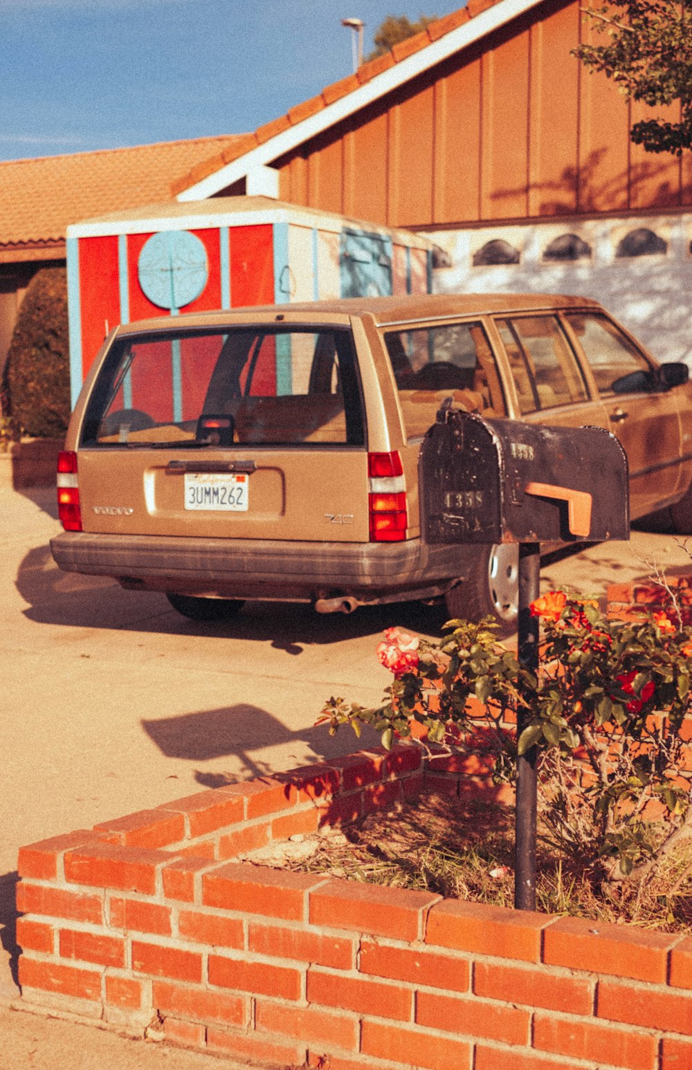 a car parked next to a mailbox in a driveway