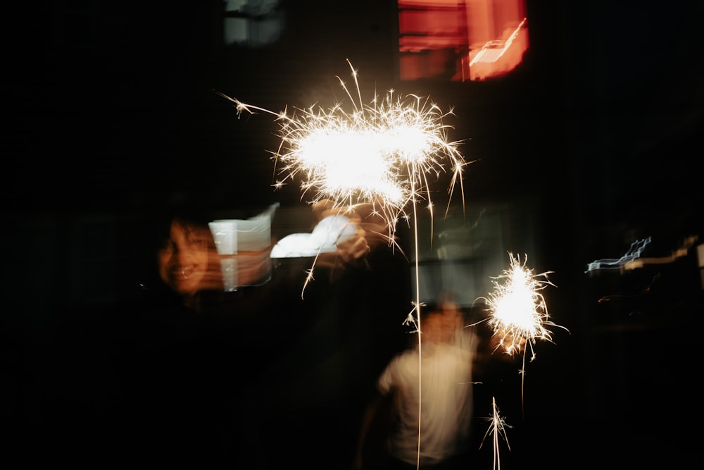 a man standing next to a firework display