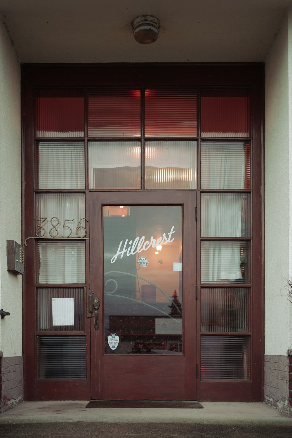 the front door of a building with a sign on it