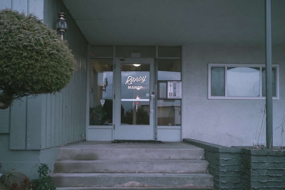 the front entrance of a building with steps leading up to it