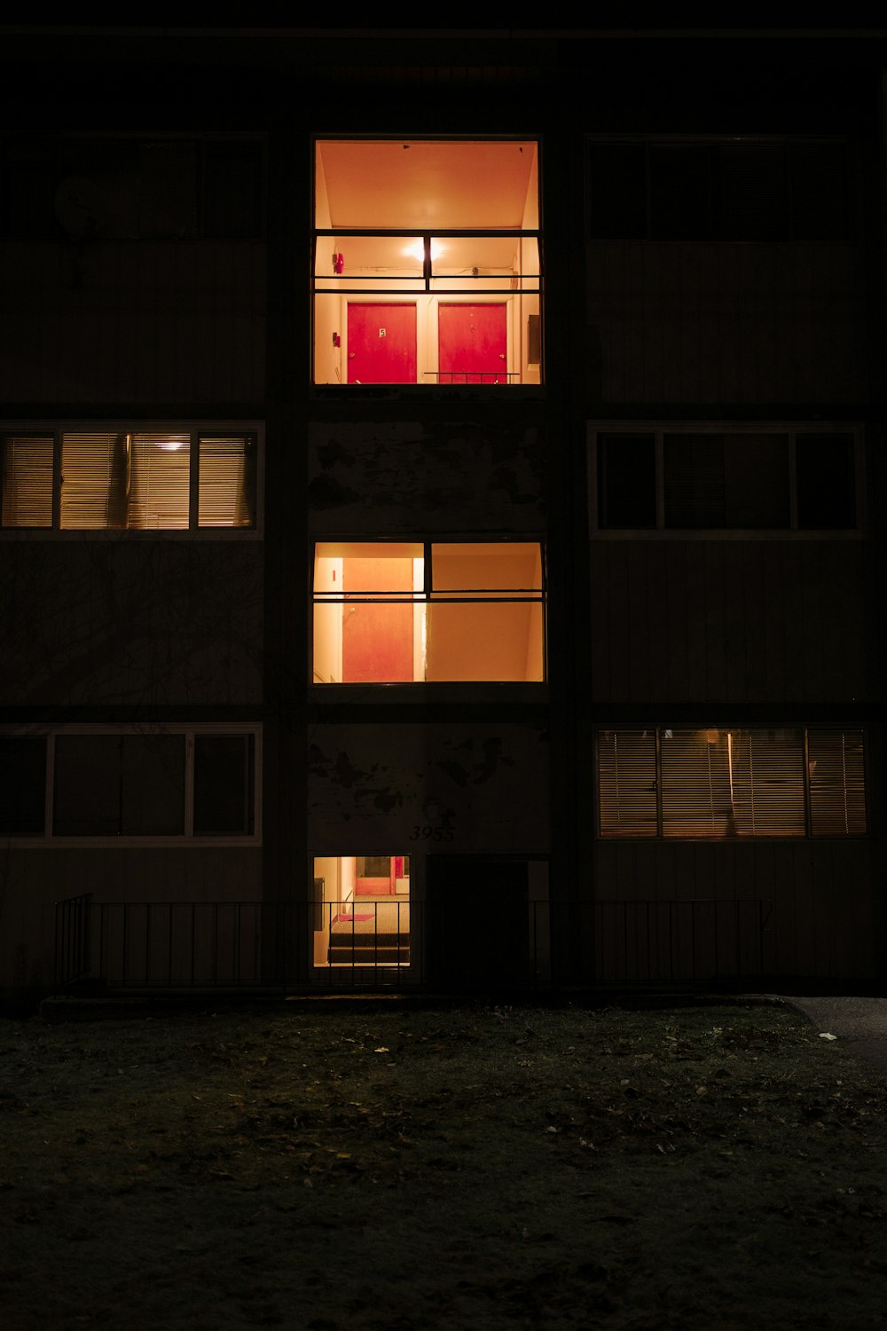 an apartment building with multiple windows lit up at night