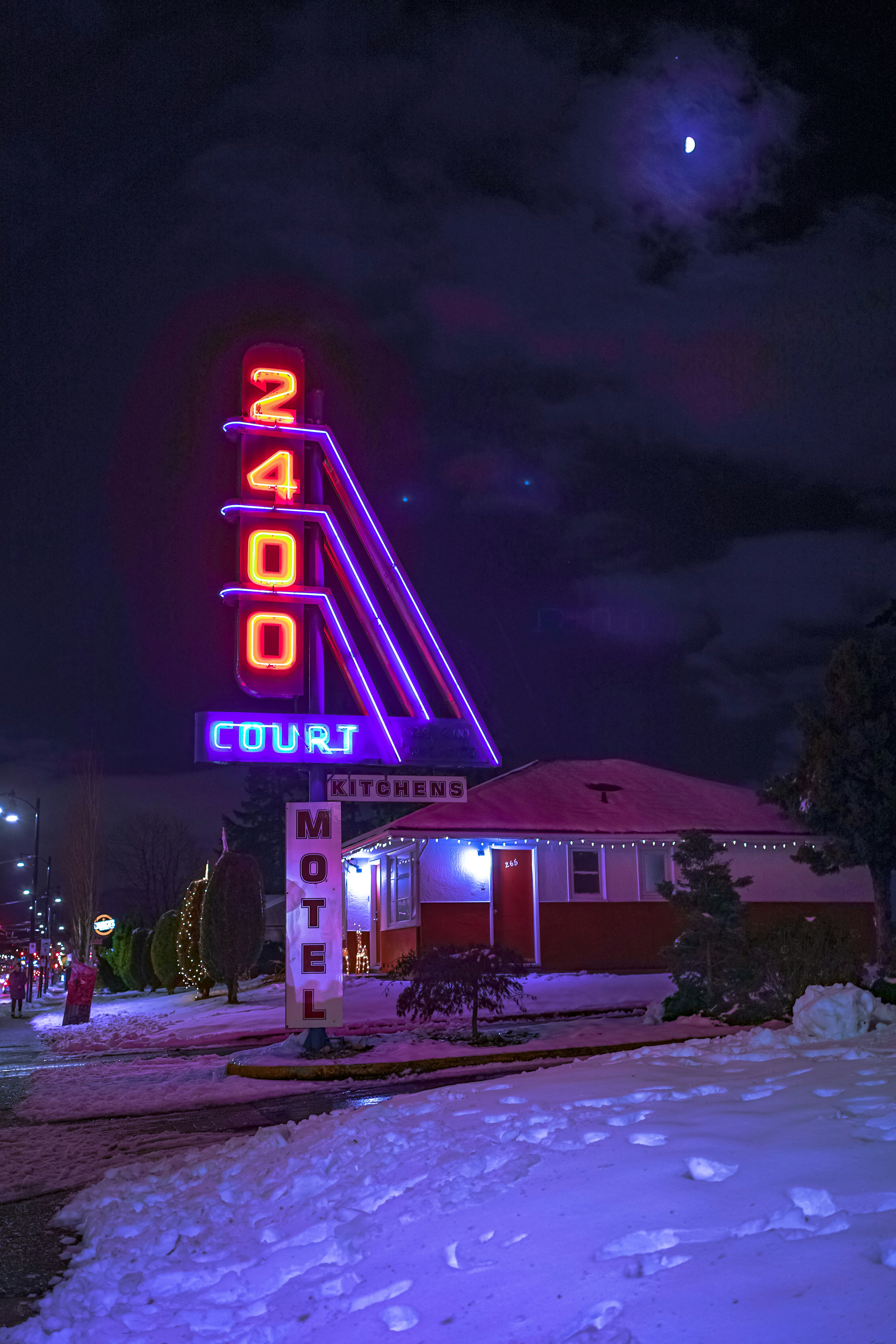 A motel sign lit up at night in the snow photo Free Motel Image on