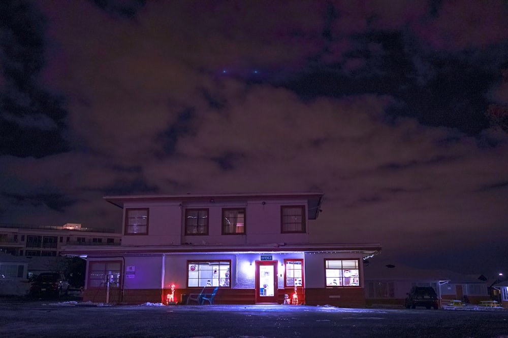 a building lit up at night with a sky background