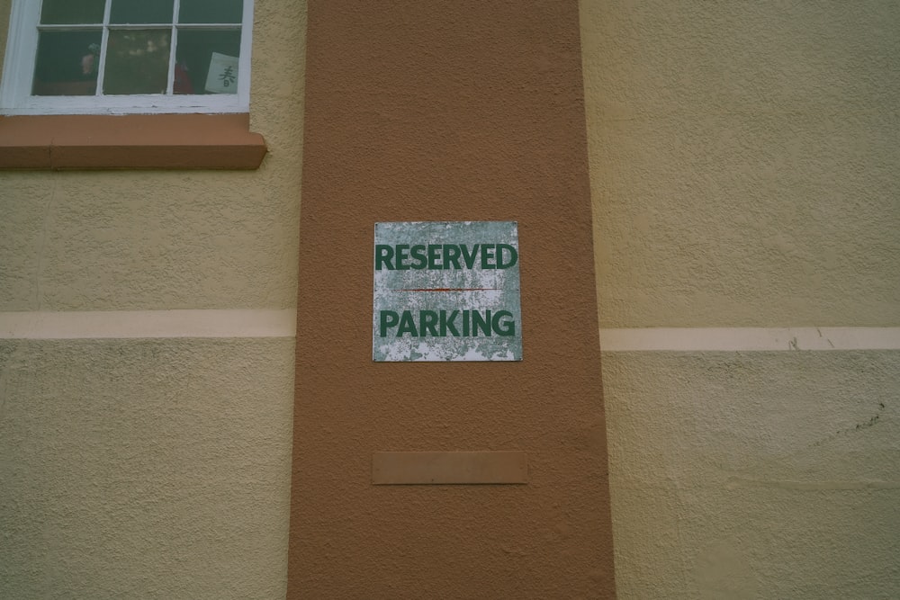 a sign on the side of a building that says reserved parking