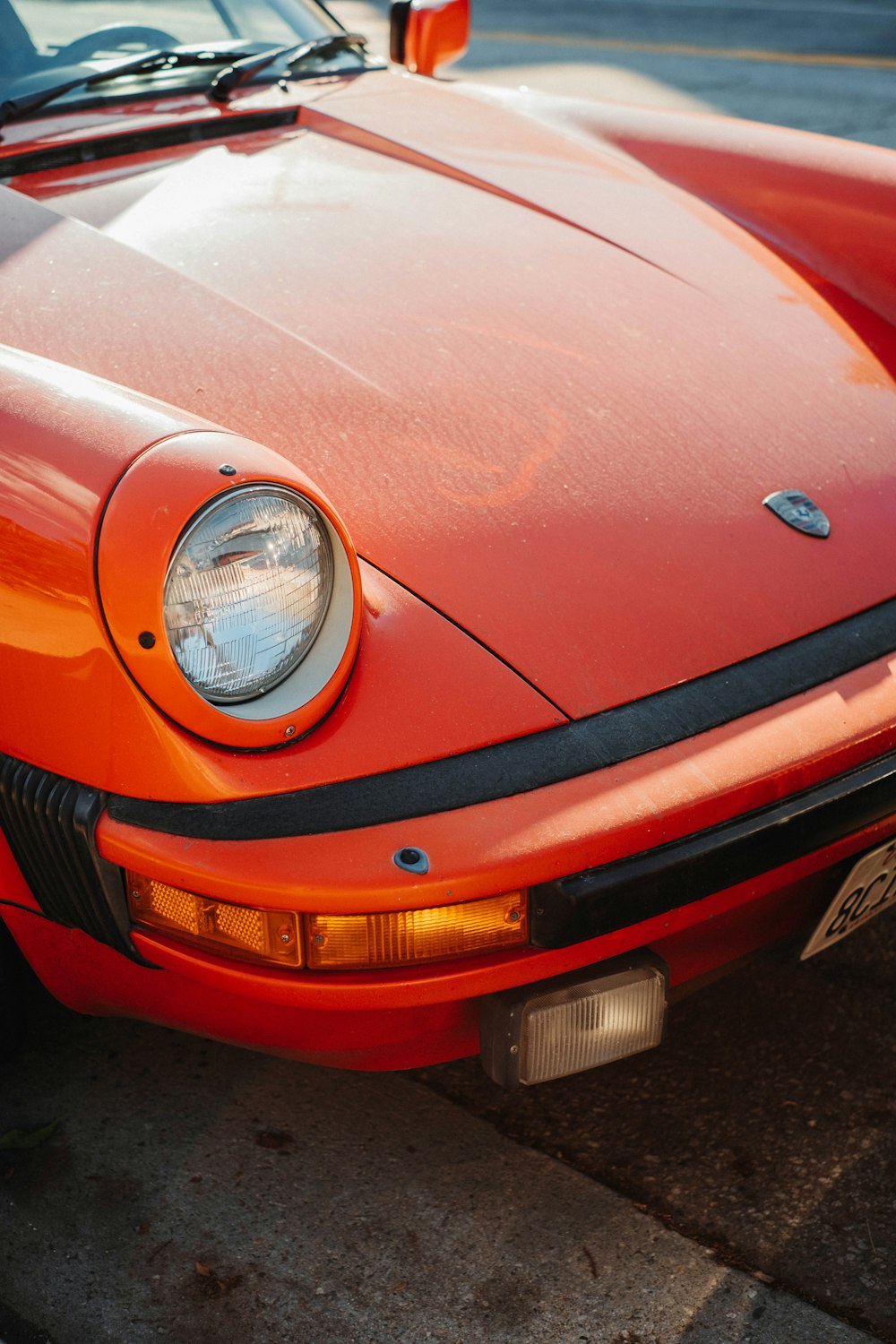 an orange sports car parked in a parking lot