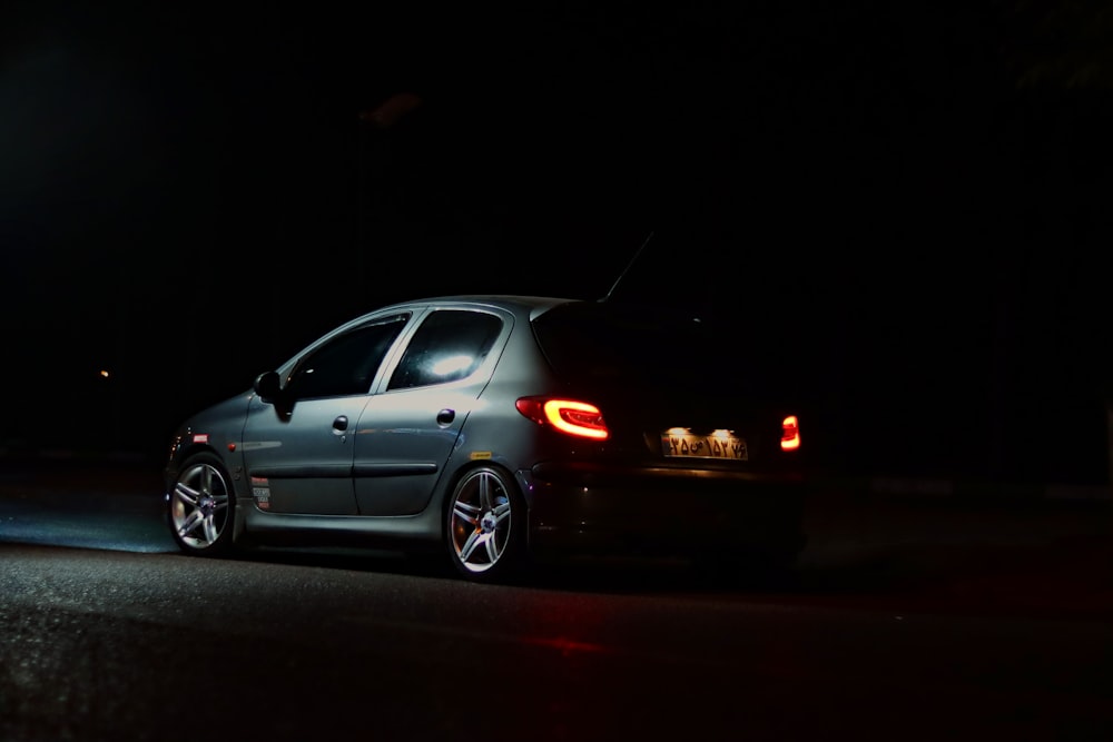 a car parked on the side of the road at night