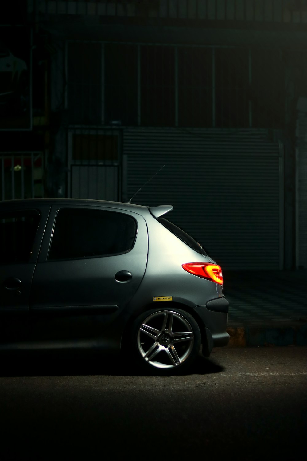 a small car parked in a parking lot at night