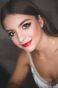 a woman with red lipstick and a necklace
