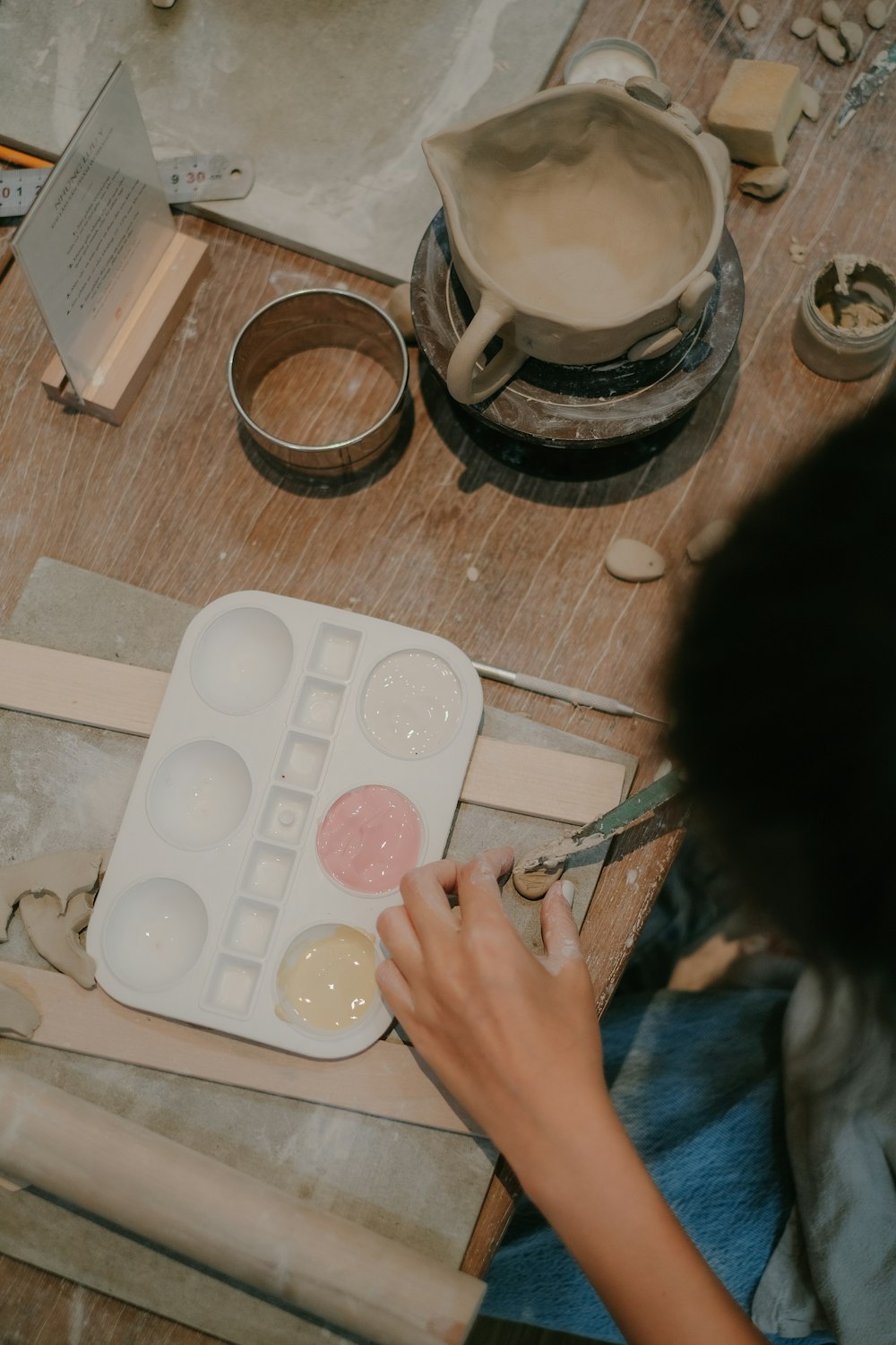 a person is painting a picture on a table