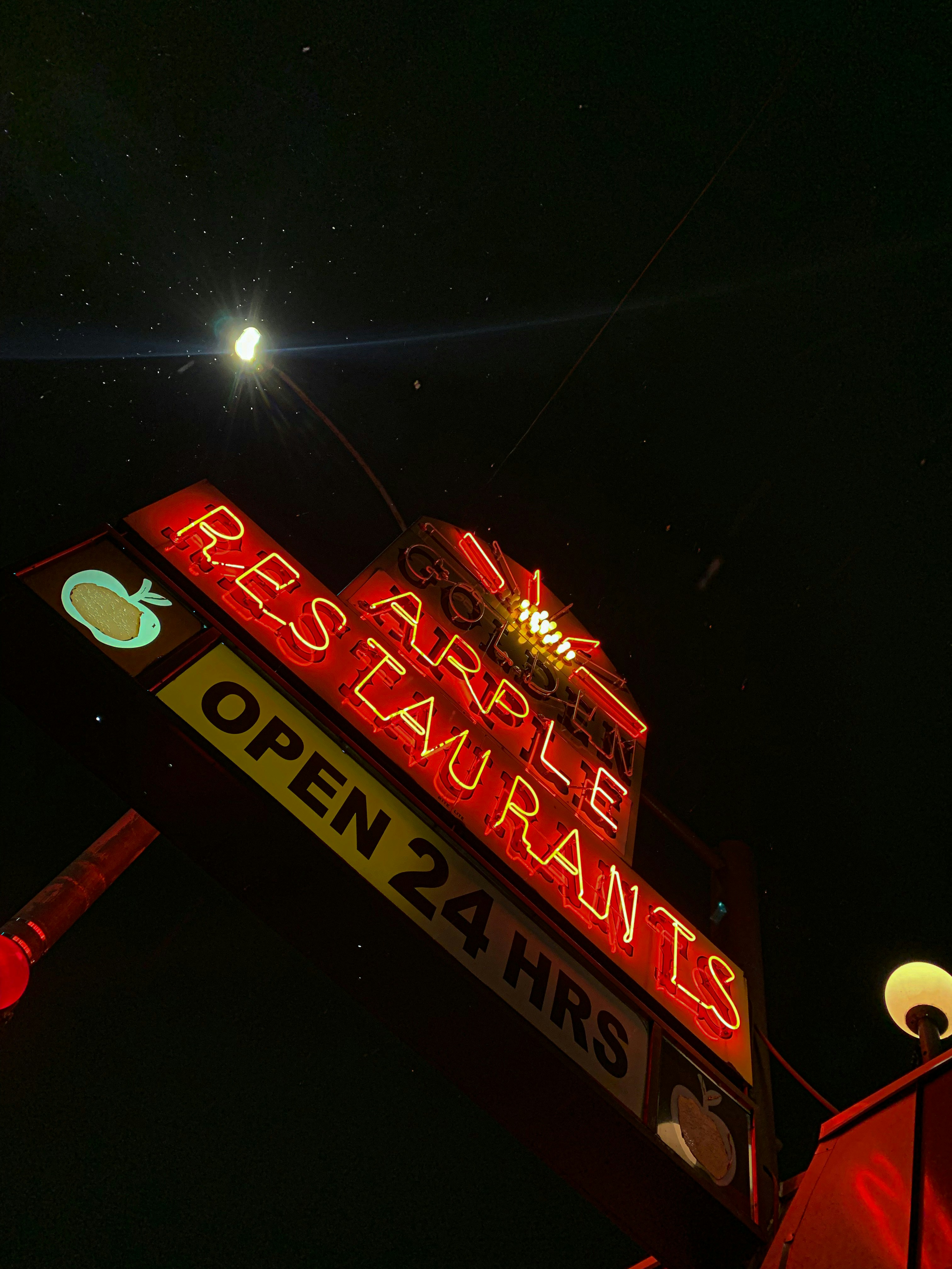 a neon sign is lit up in the dark