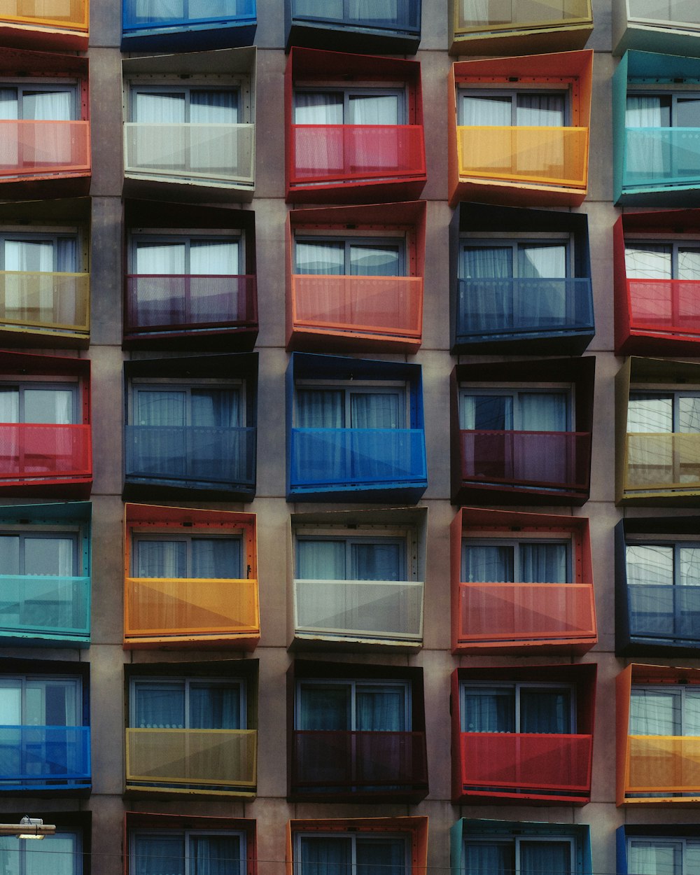 Un edificio multicolore con più finestre e balconi