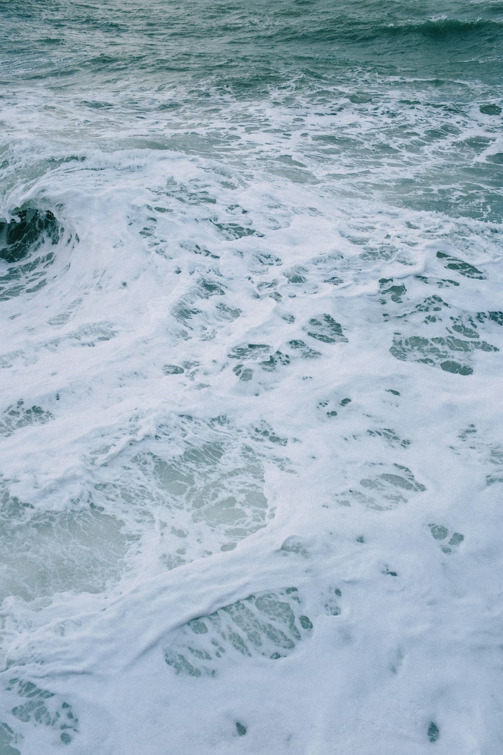 a person riding a surfboard on top of a wave