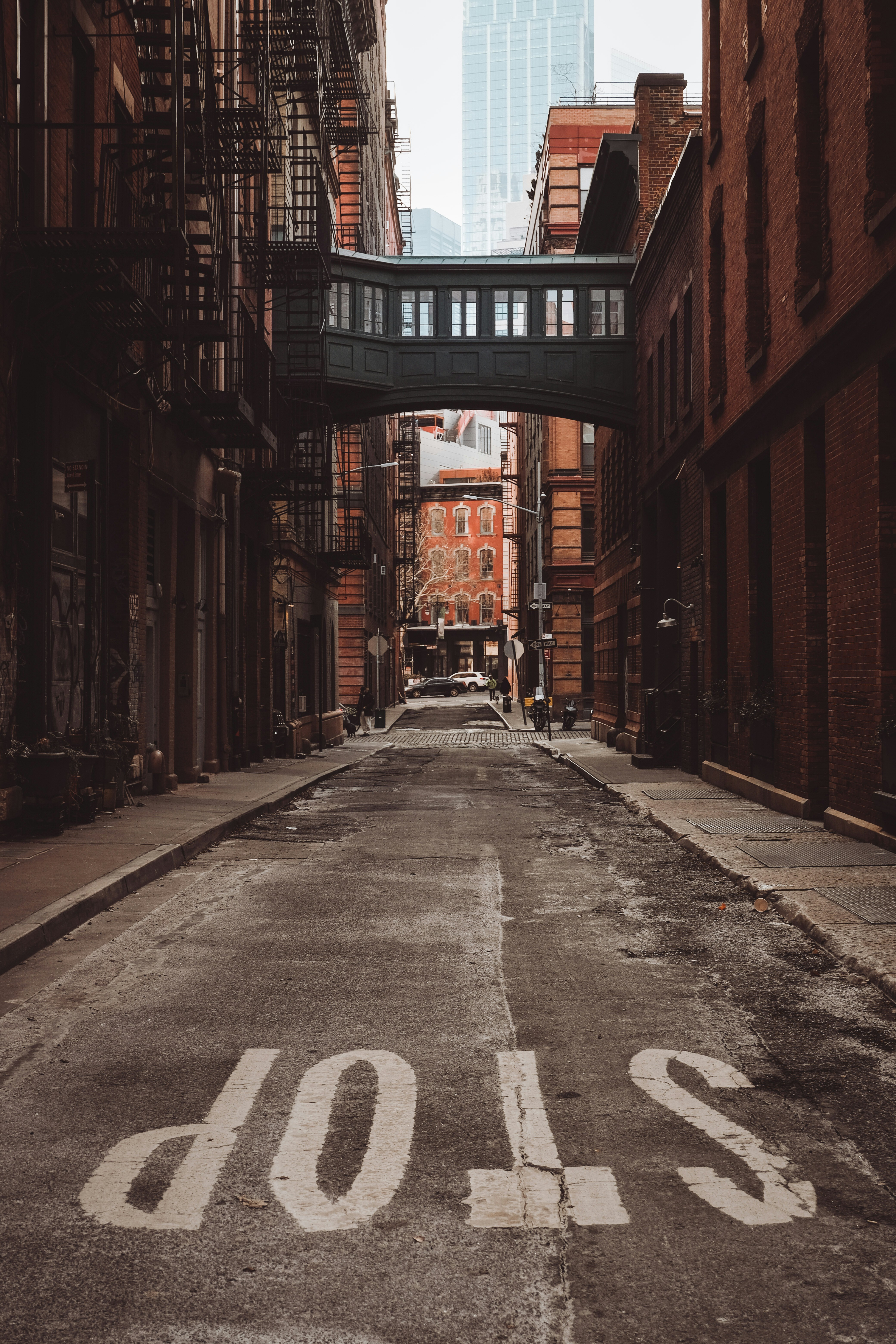 an empty street with a bridge over it