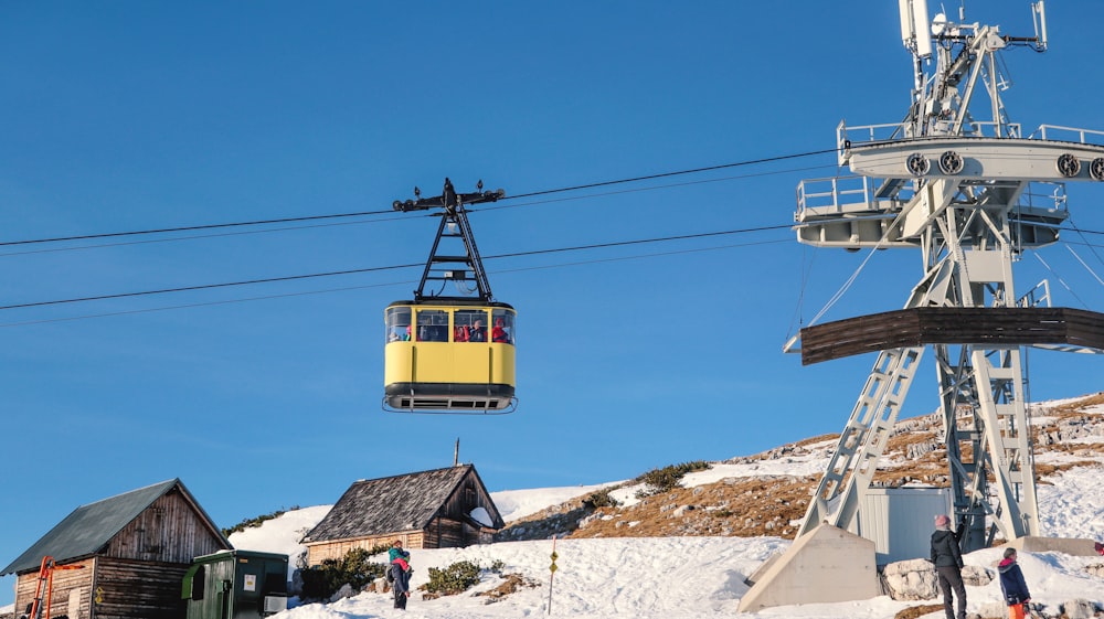 a ski lift going up the side of a snow covered mountain