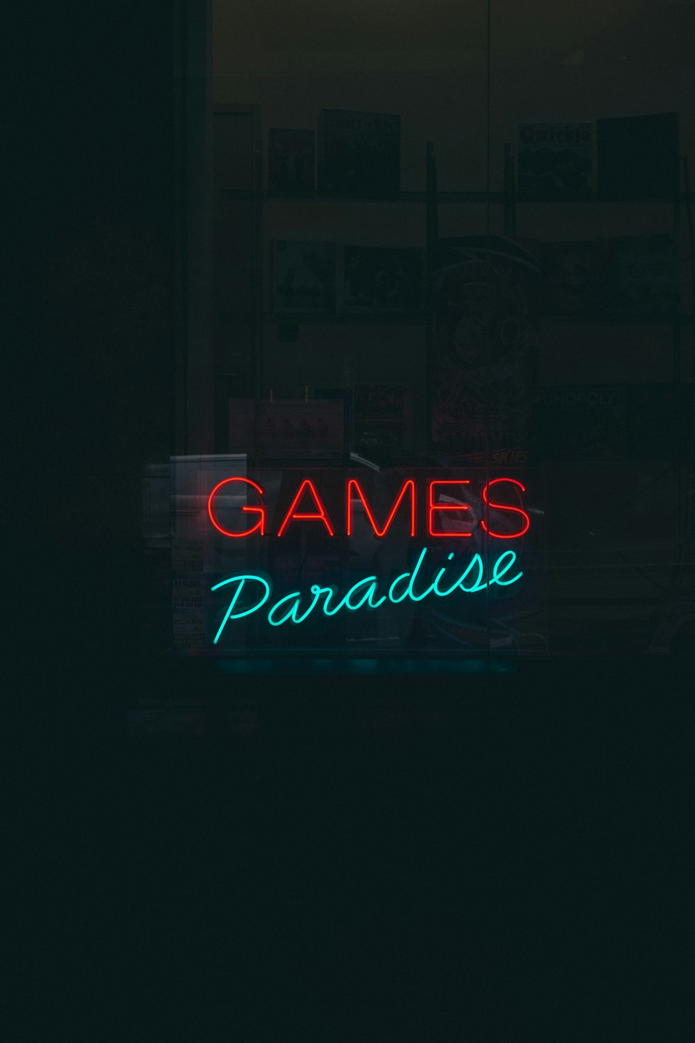 a neon sign that reads games paradise