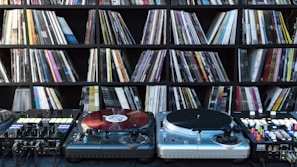 A collection of vinyl records and music equipment in a studio.