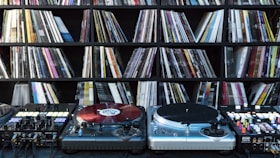Close-up of vintage vinyl records stacked beside modern digital music equipment, symbolizing dj nijgman’s evolution.