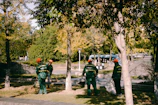 Team members in green uniforms performing safety checks during cleaning service.