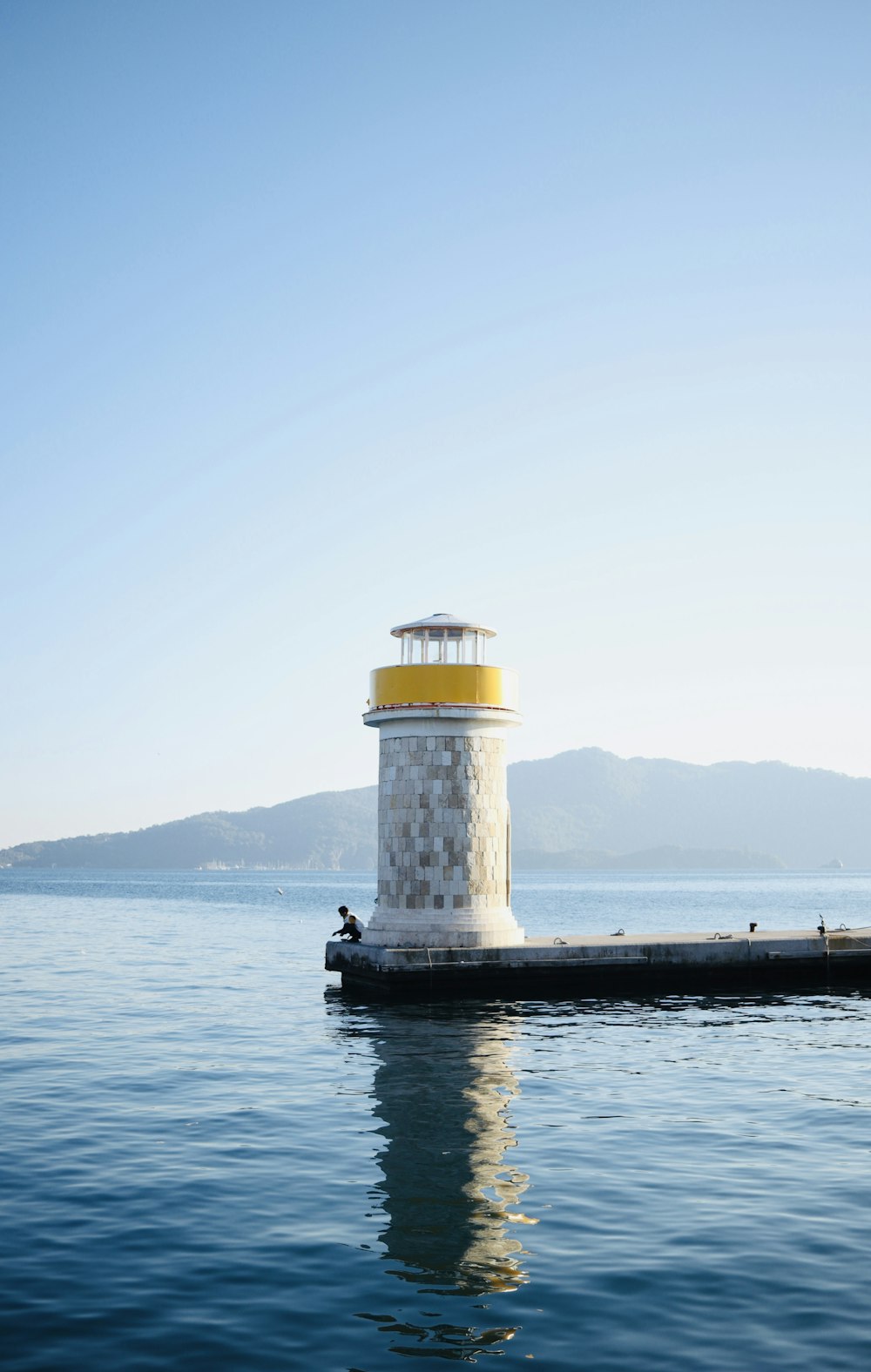 a light house sitting on top of a body of water