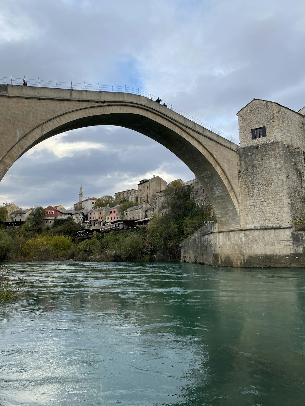 a bridge over a body of water with buildings in the background