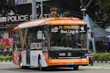 Electric school bus on a sunny Lagos street, representing kabu’s eco-friendly service.