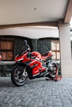 a red motorcycle parked in front of a building
