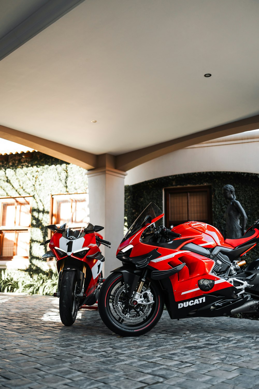 a red motorcycle parked in front of a building