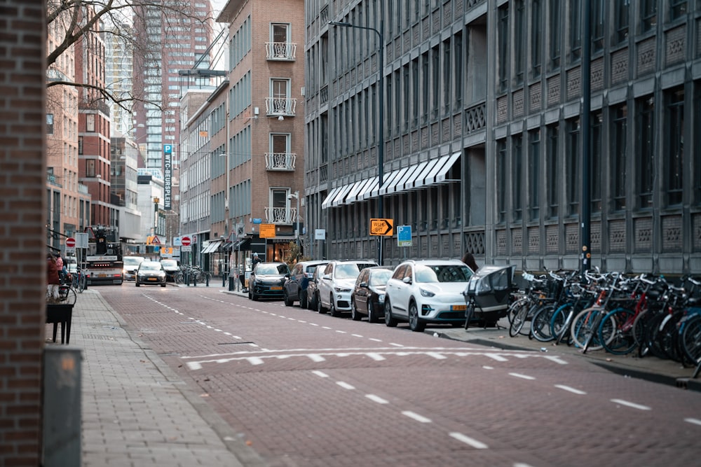 a city street filled with lots of traffic next to tall buildings