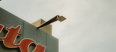 Metal building signage mounted above a storefront entrance.