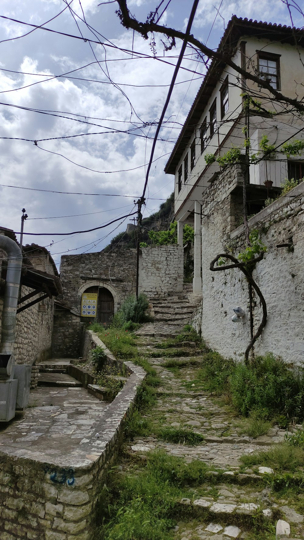 a cobblestone street with stone steps leading up to a building