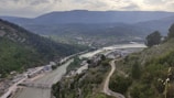 A scenic view of a river winding through a lush green valley.