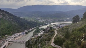 A scenic view of a river winding through a lush green valley.