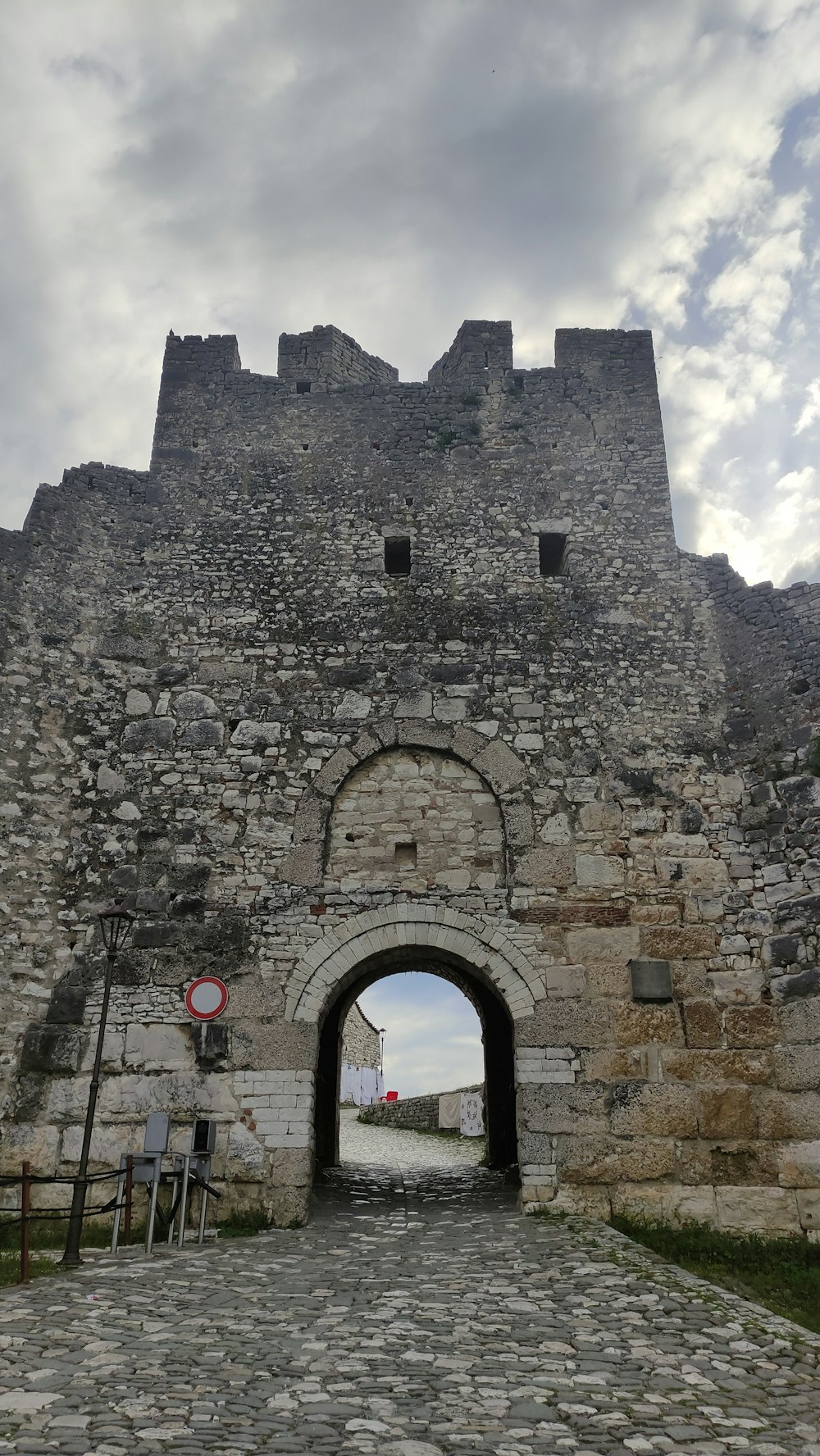 a stone gate leading to an old castle