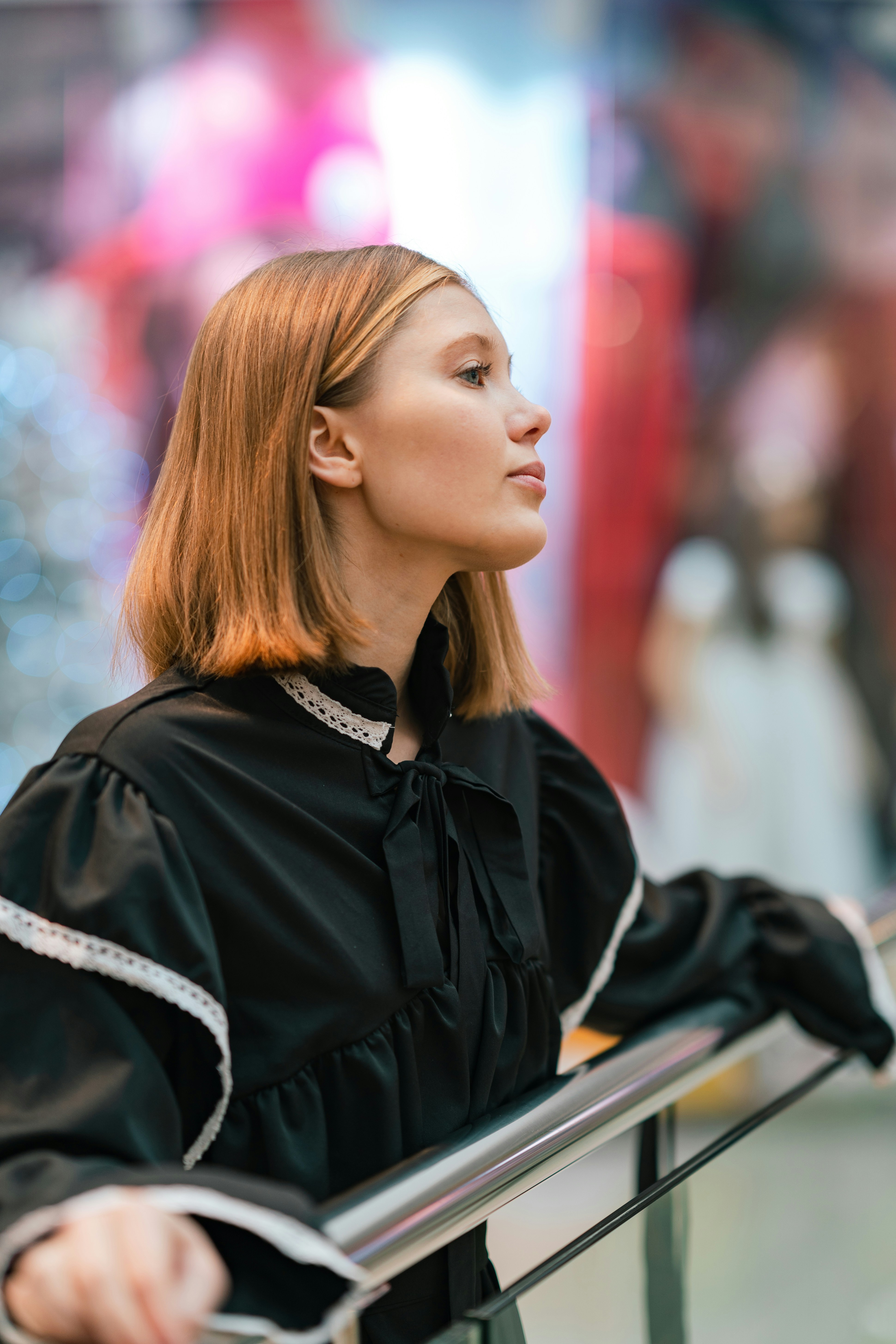 a woman sitting on a bench in a black dress