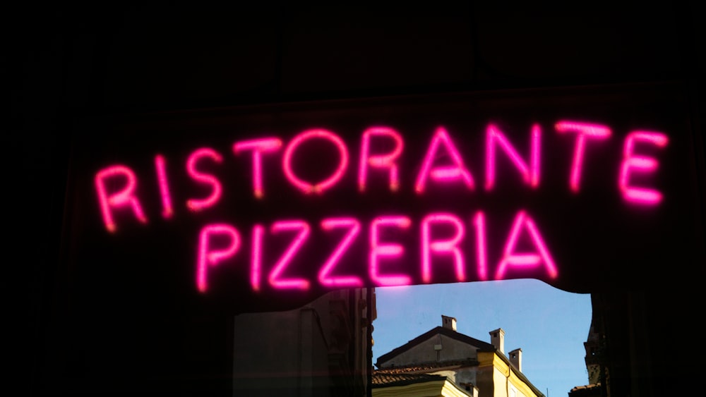 a neon sign that reads ristorante pizzaria