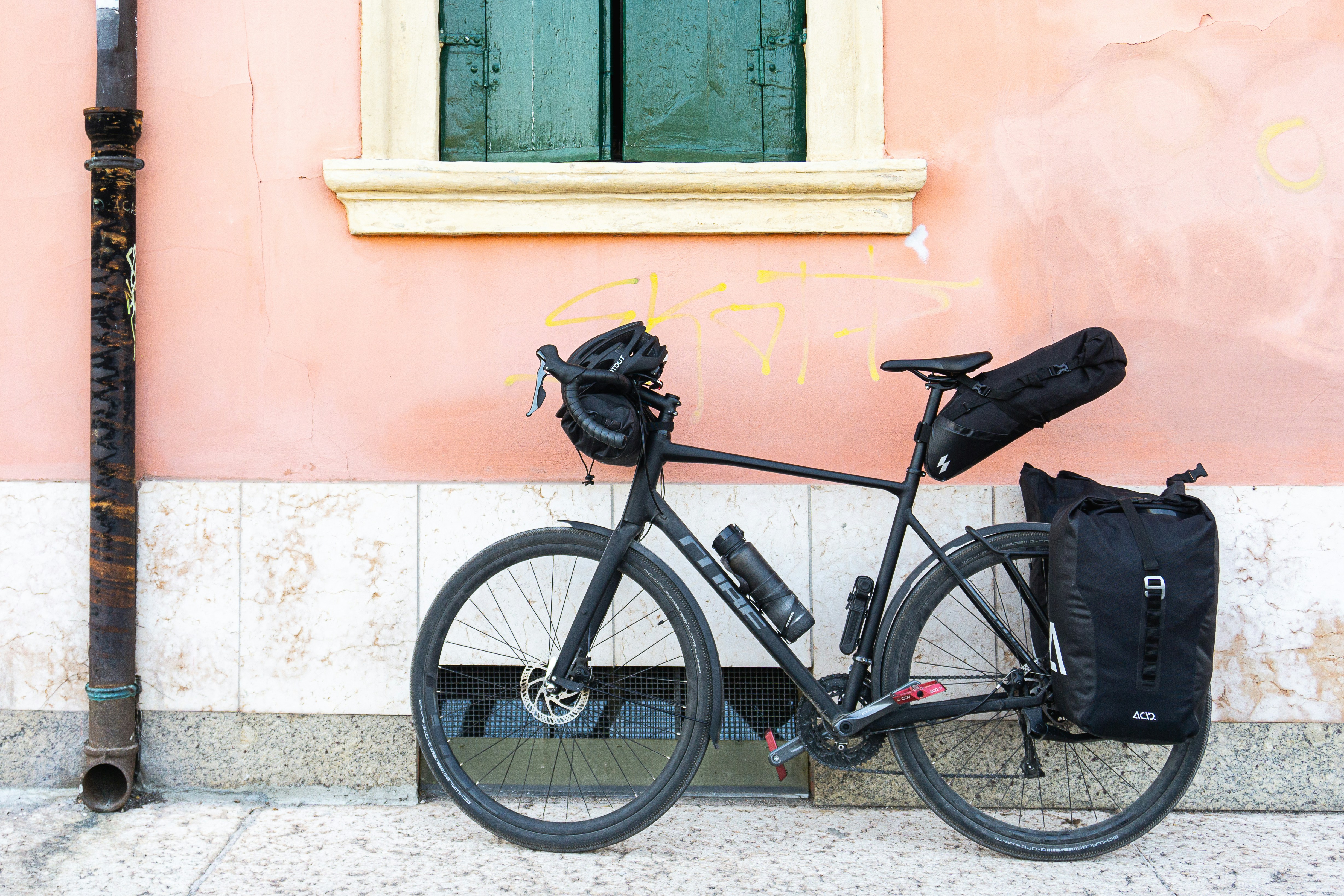 a bicycle parked next to a building with graffiti on it