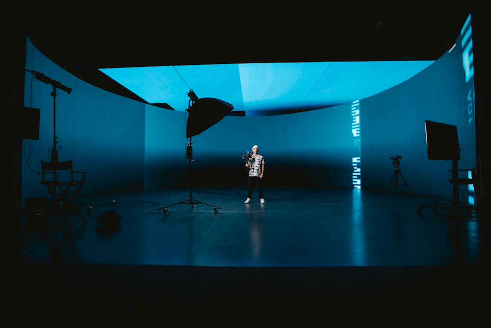 a person standing on a stage in a dark room