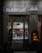 A dimly lit shop window displays a person inside, working on a counter with kitchen tools. Decorative fairy lights adorn the shopfront, and an illuminated display case is visible to the right. The signage above the window features Cyrillic lettering.