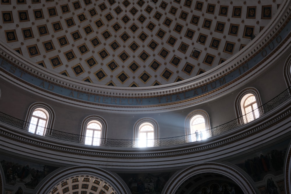 the ceiling of a large building with many windows