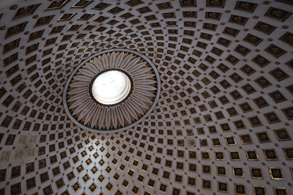 the ceiling of a building with a circular window