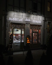 A vibrant storefront of a family-run bakery with colorful window displays