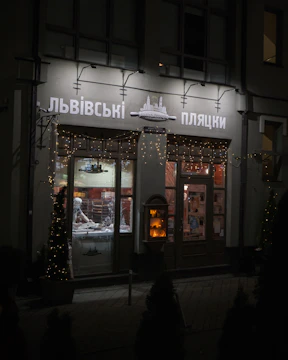 A vibrant storefront of a family-run bakery with colorful window displays