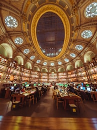 a library filled with lots of books and lots of windows