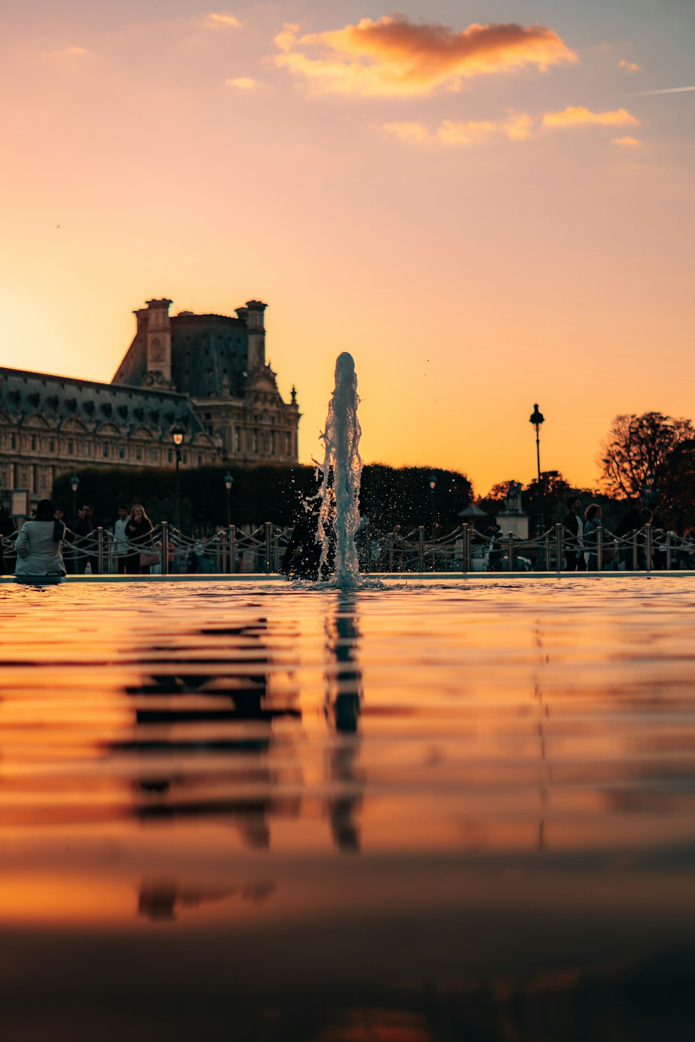 a water fountain with a building in the background