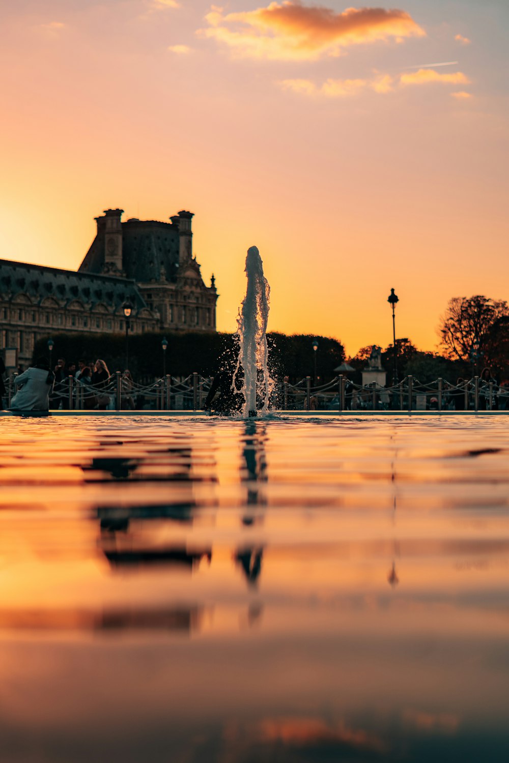 a water fountain with a building in the background