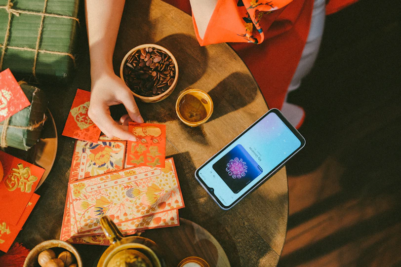 a person sitting at a table with a cell phone
