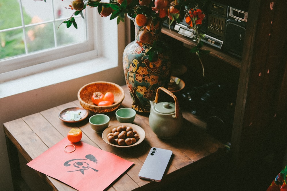 a wooden table topped with bowls of food