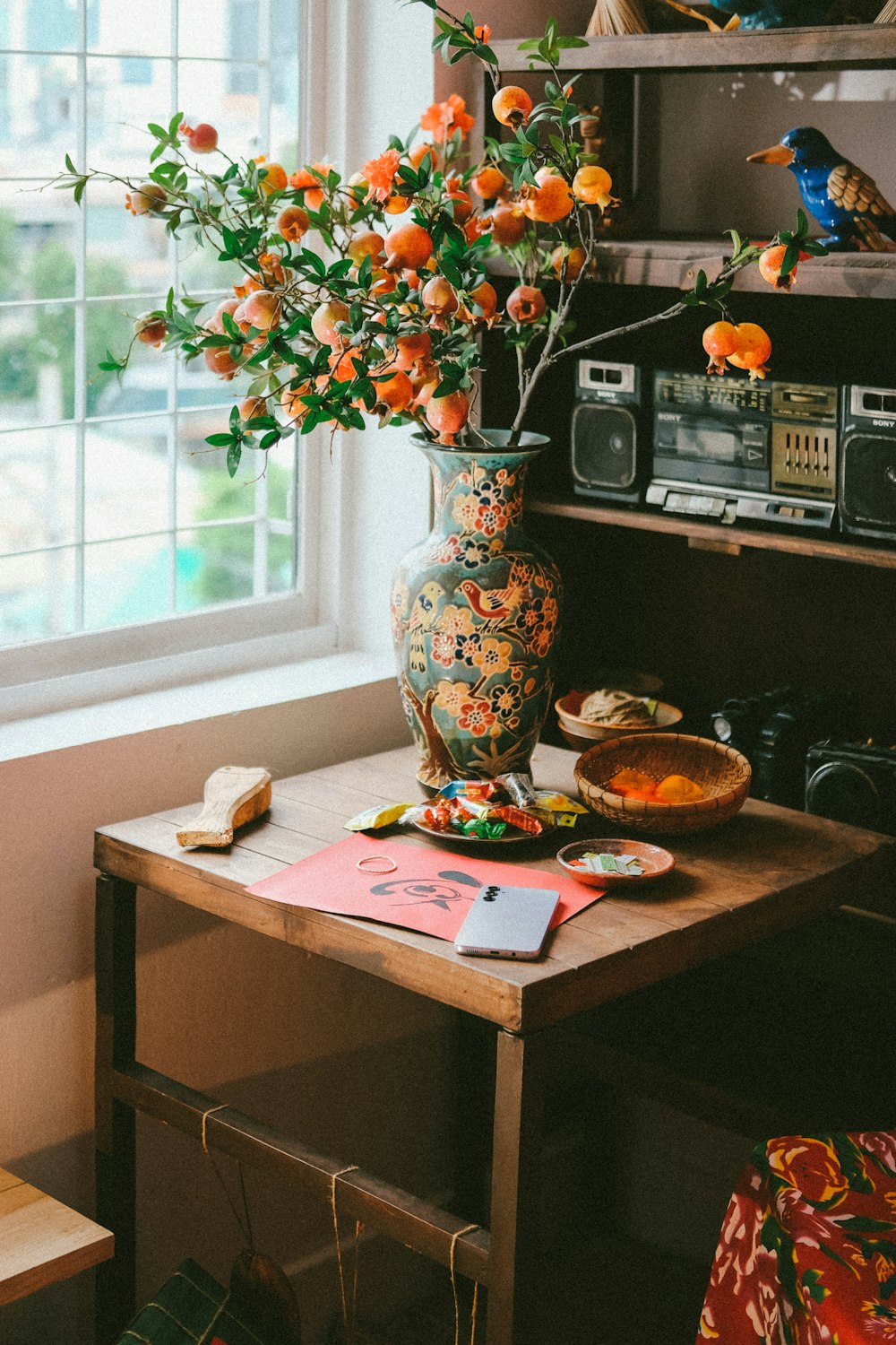 a vase filled with orange flowers on top of a wooden table