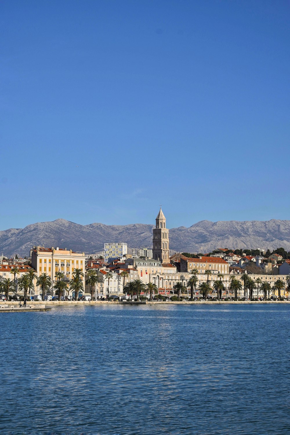 a large body of water with a city in the background